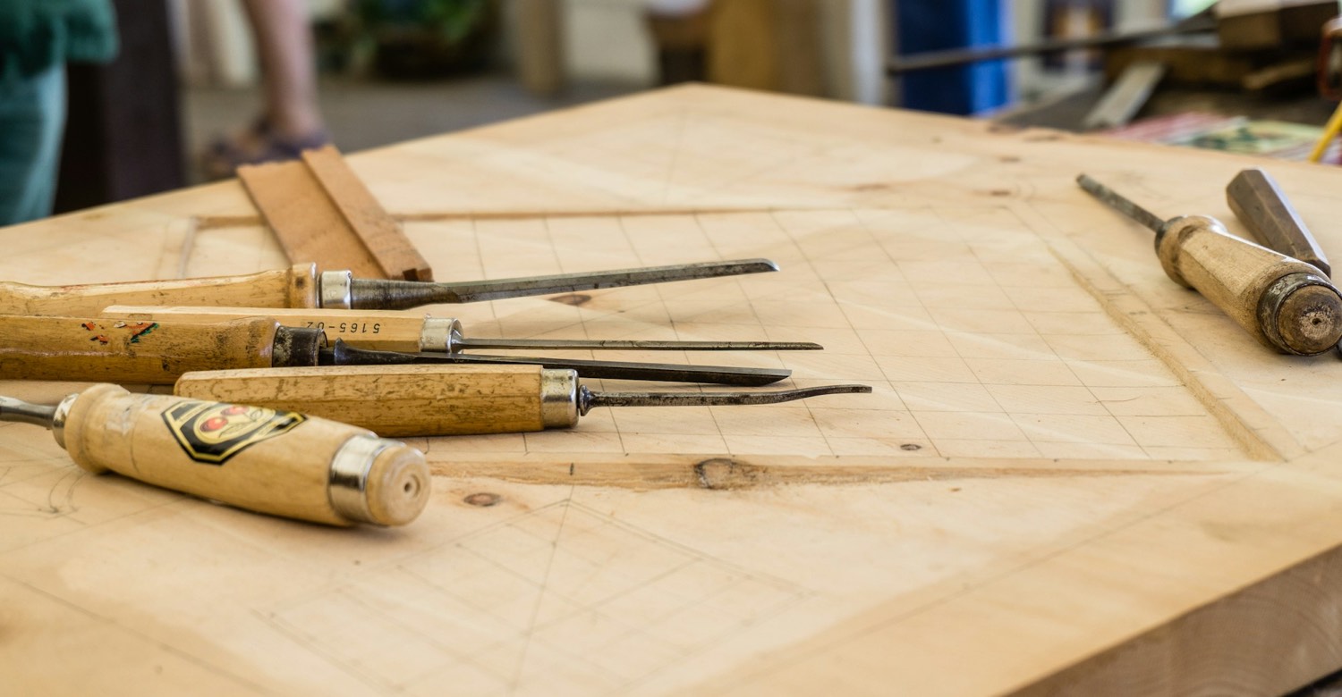 Hand tools laid out on a workbench